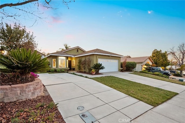 single story home with a garage, driveway, and stucco siding