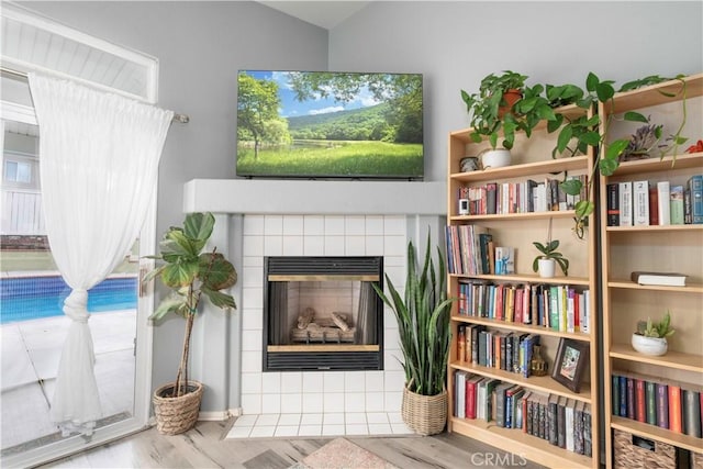 sitting room with wood finished floors and a fireplace