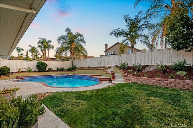 view of swimming pool with a yard, a fenced in pool, and a fenced backyard