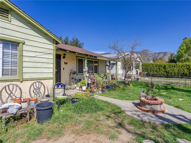 view of yard featuring fence and a mountain view