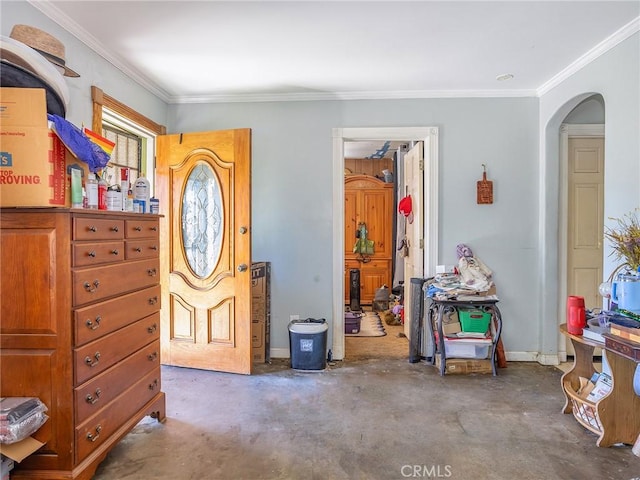 entrance foyer with unfinished concrete floors, arched walkways, and ornamental molding