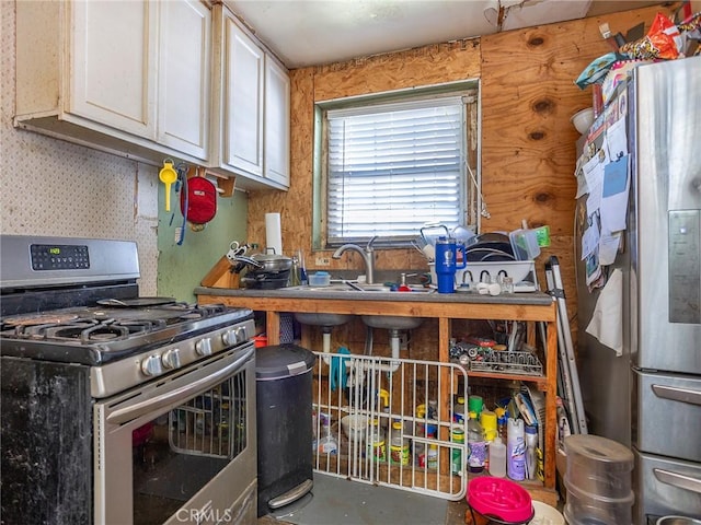 kitchen featuring white cabinetry, stainless steel appliances, and a sink