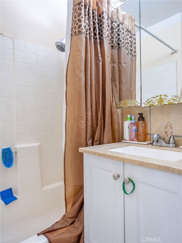 full bath featuring decorative backsplash, shower / tub combo with curtain, and vanity