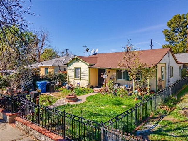 view of front of property featuring a patio, a front lawn, a fire pit, a jacuzzi, and fence private yard