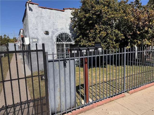 view of gate with a yard and fence