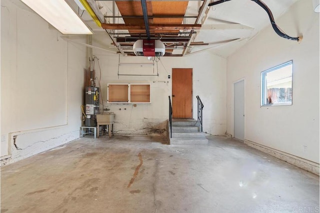 garage featuring water heater and a garage door opener