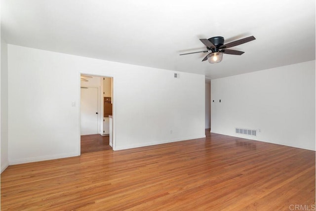 empty room with visible vents, baseboards, ceiling fan, and light wood finished floors