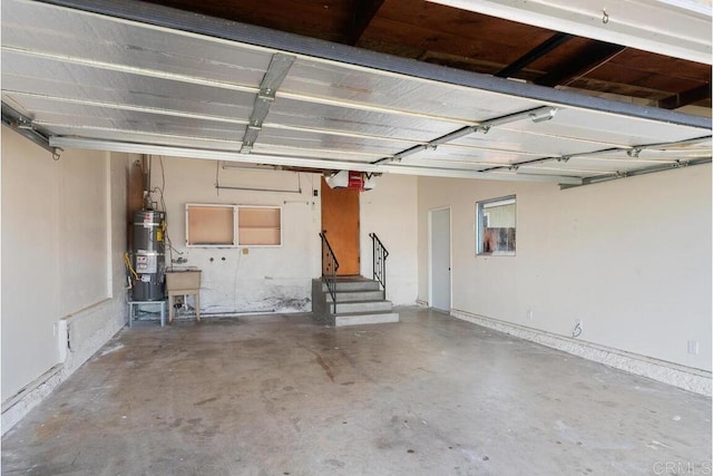 garage featuring strapped water heater and a garage door opener