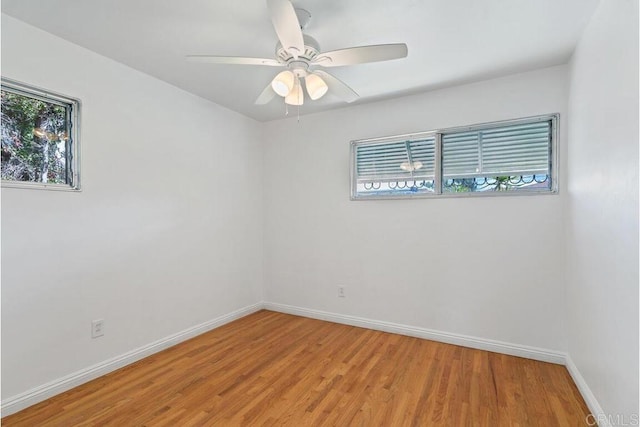 spare room with light wood-style flooring, baseboards, and ceiling fan