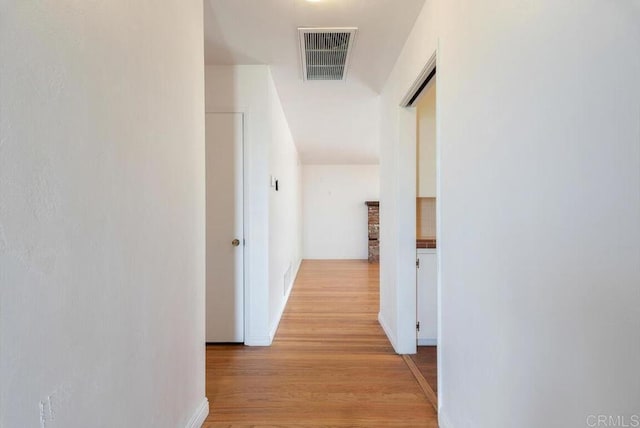 hallway with visible vents and light wood finished floors