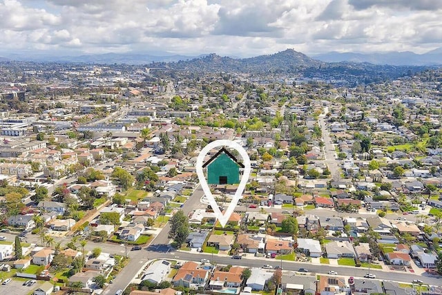 birds eye view of property with a mountain view and a residential view