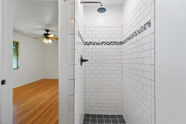 full bathroom with baseboards, tiled shower, a ceiling fan, and wood finished floors