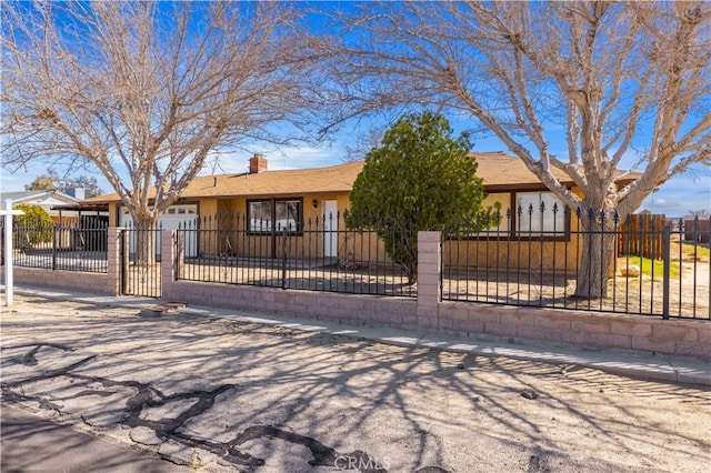 single story home featuring a fenced front yard and stucco siding