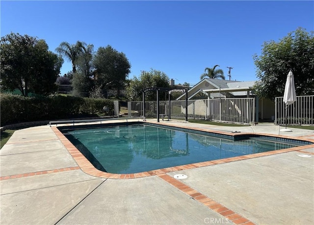 view of pool with a patio area, a fenced in pool, and fence