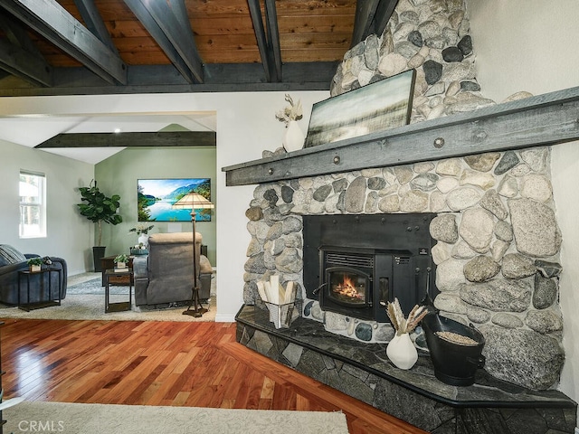details with beamed ceiling, a fireplace, wood finished floors, and baseboards