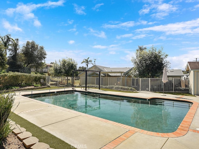 view of swimming pool featuring a fenced in pool, fence, and a patio