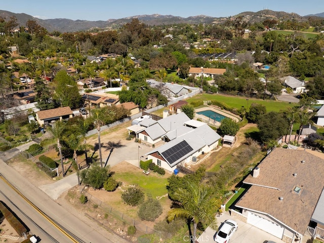 drone / aerial view featuring a residential view and a mountain view