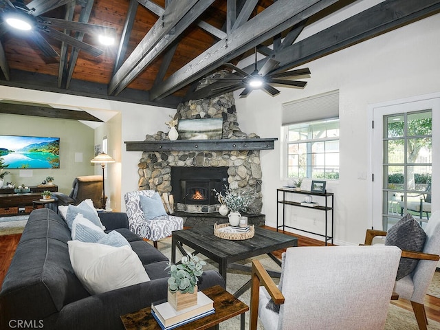 living room featuring a ceiling fan, wood finished floors, beamed ceiling, and a wealth of natural light