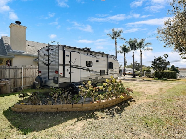view of yard with driveway and fence