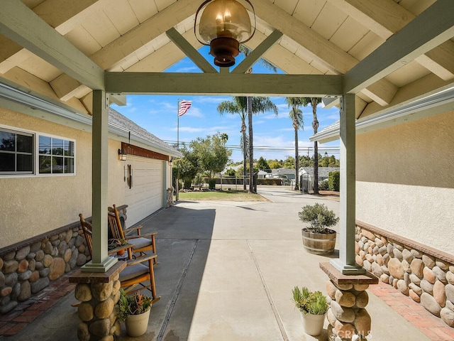 view of patio / terrace featuring driveway and an attached garage