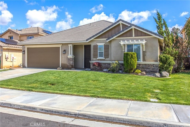 craftsman-style home featuring a garage, stone siding, a front yard, and driveway