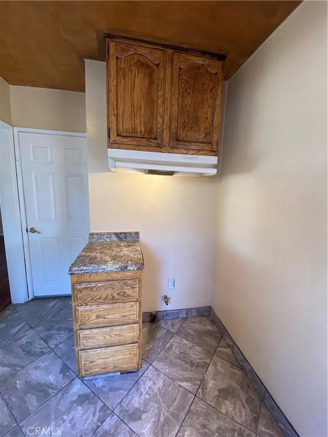 laundry area featuring baseboards