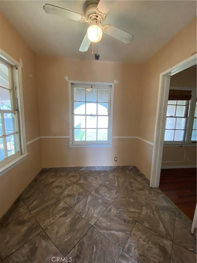 unfurnished room with ceiling fan