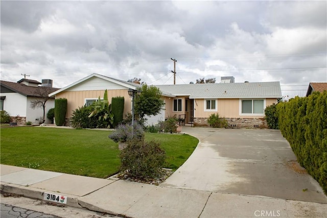 ranch-style house with a front yard and driveway