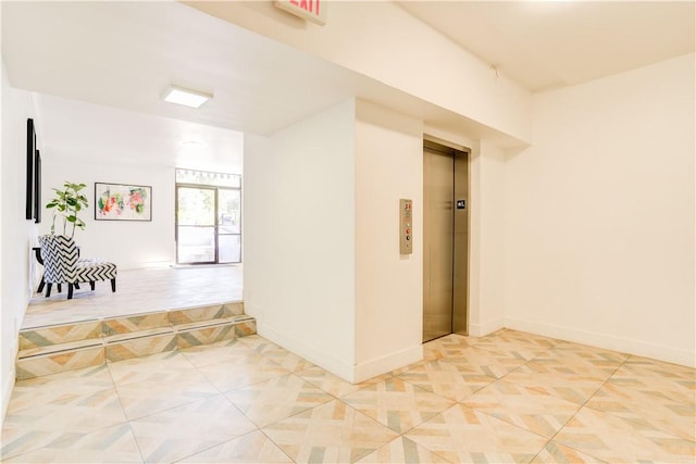 empty room with baseboards and elevator