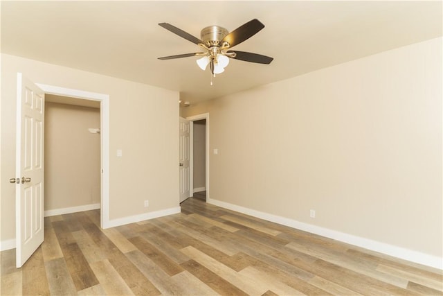 unfurnished bedroom featuring baseboards, ceiling fan, and light wood finished floors