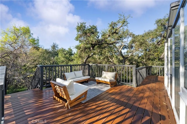 wooden terrace featuring an outdoor hangout area