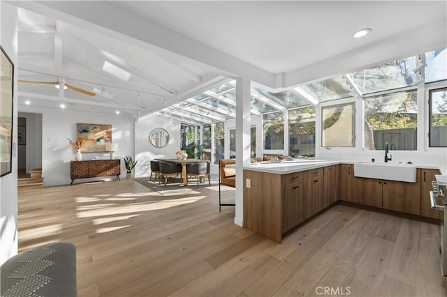 sunroom / solarium featuring a sink and vaulted ceiling with beams