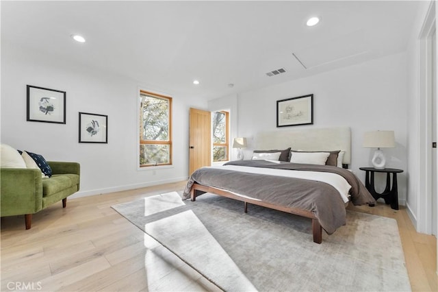 bedroom featuring recessed lighting, visible vents, light wood-style flooring, and attic access