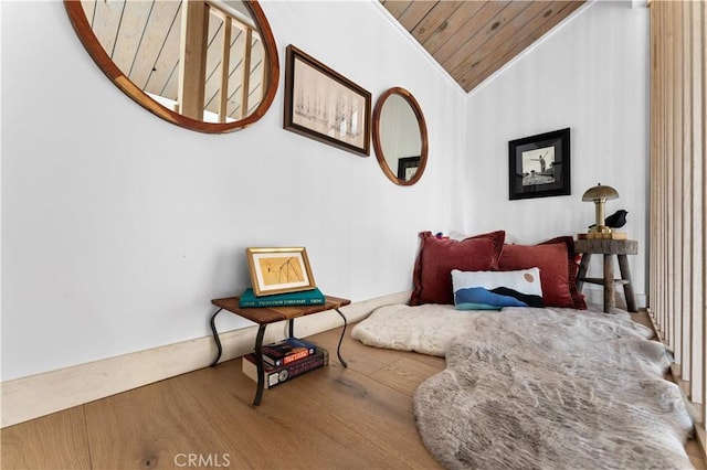 sitting room featuring wood ceiling, wood finished floors, crown molding, and vaulted ceiling