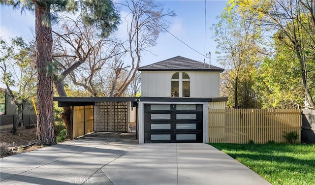 exterior space with an attached garage, driveway, and fence