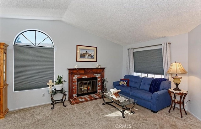 living room with a textured ceiling, baseboards, carpet flooring, a fireplace, and lofted ceiling