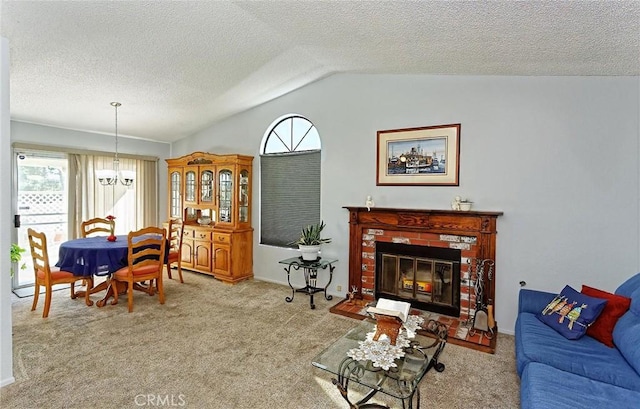 living area with plenty of natural light, a notable chandelier, carpet floors, and vaulted ceiling