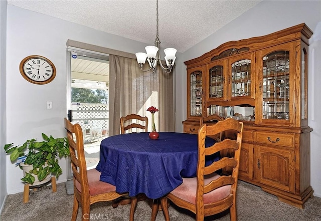 dining area with an inviting chandelier, a textured ceiling, lofted ceiling, and carpet