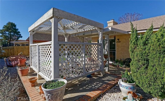 view of patio featuring a pergola and fence