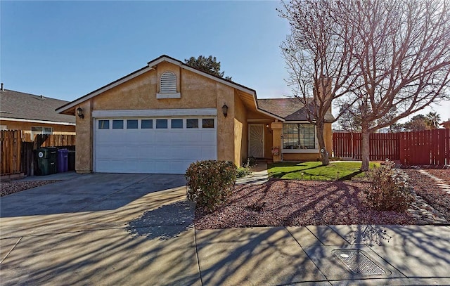 ranch-style home featuring stucco siding, an attached garage, concrete driveway, and fence