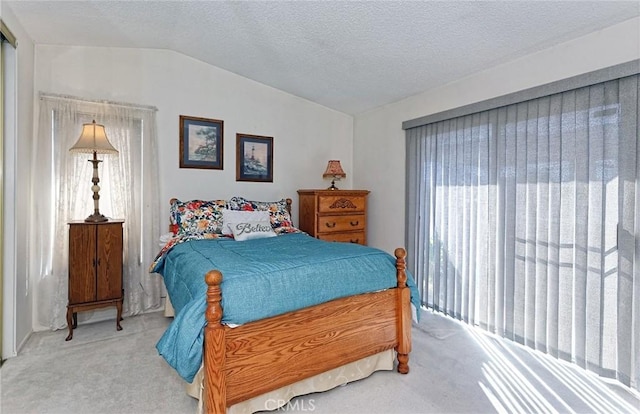 bedroom featuring carpet floors, a textured ceiling, and vaulted ceiling