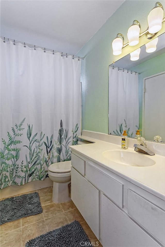 full bathroom with tile patterned floors, a shower with shower curtain, toilet, and vanity