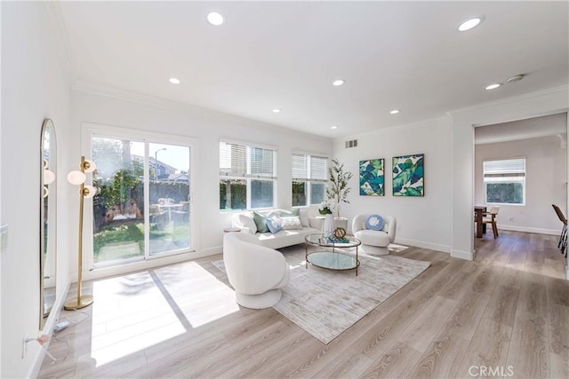 living room featuring recessed lighting, visible vents, light wood-style flooring, and ornamental molding