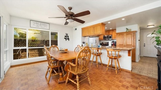 dining space with recessed lighting, baseboards, and ceiling fan