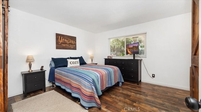 bedroom featuring baseboards and wood finished floors