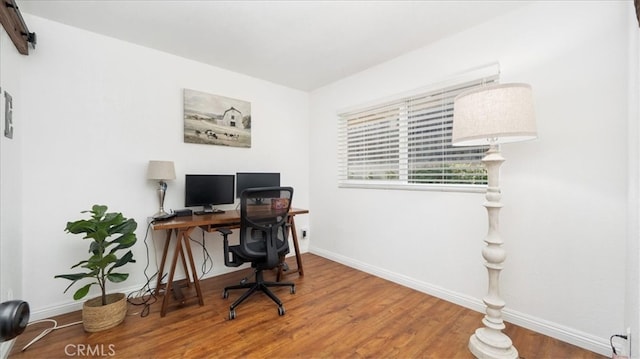 home office with wood finished floors and baseboards