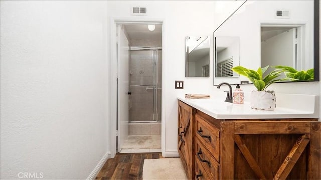 full bathroom featuring double vanity, visible vents, and a stall shower