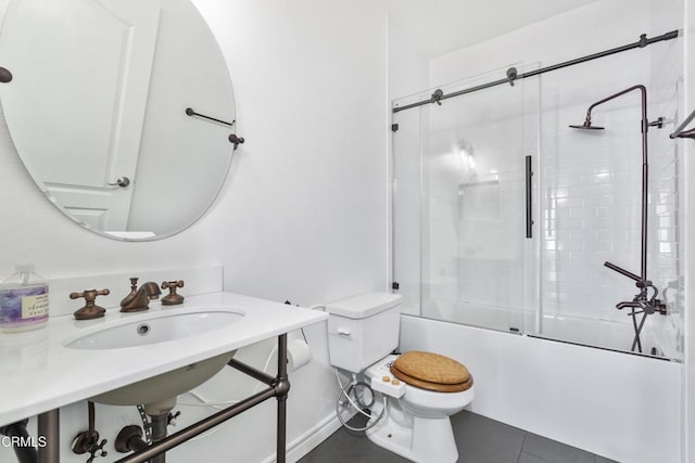 full bath with tile patterned floors, combined bath / shower with glass door, and toilet