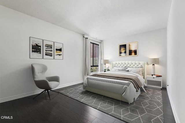 bedroom featuring dark wood-type flooring and baseboards