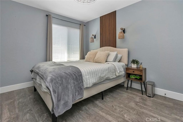 bedroom with wood finished floors and baseboards